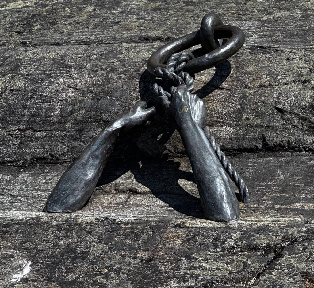 Bronze Hands of Time sculpture holding a heavy chain, symbolizing Victoria's maritime heritage and working waterfront.