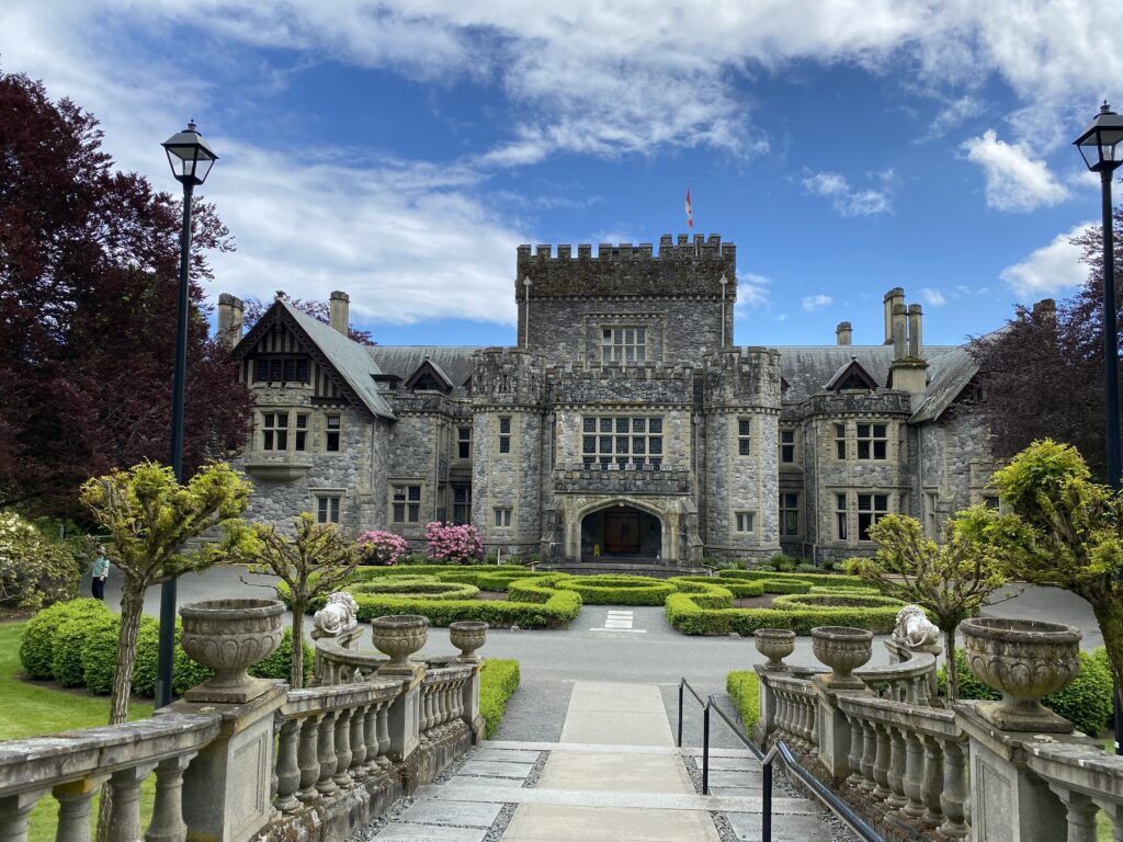 Front entrance of Hatley Castle framed by stone steps and formal gardens in Victoria, British Columbia.