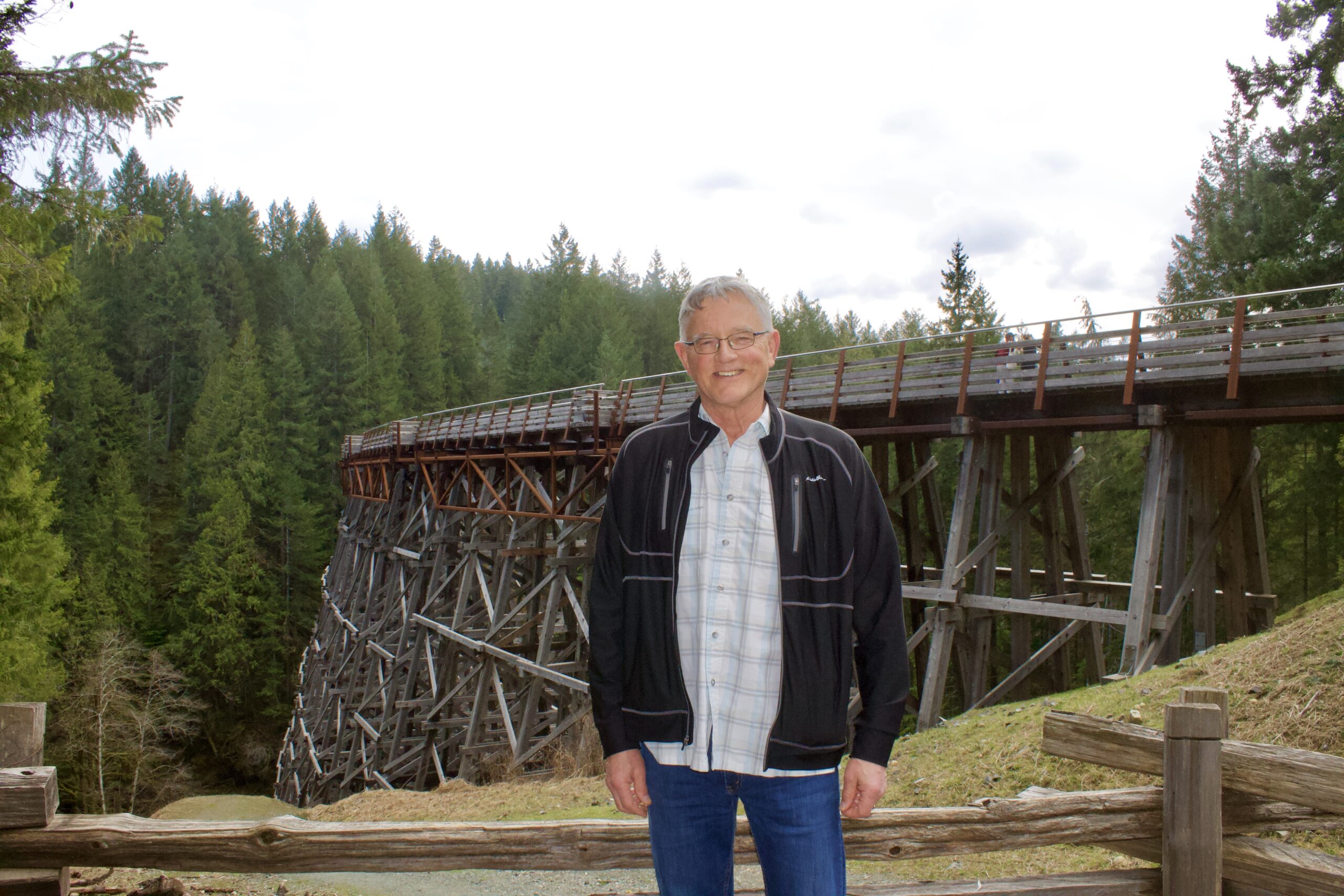 a man standing in front of a fence